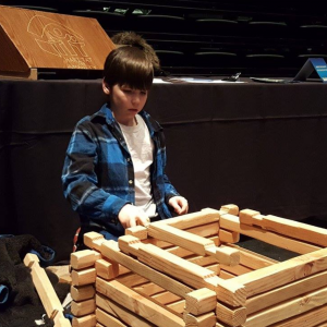 boy playing with interlocking building blocks